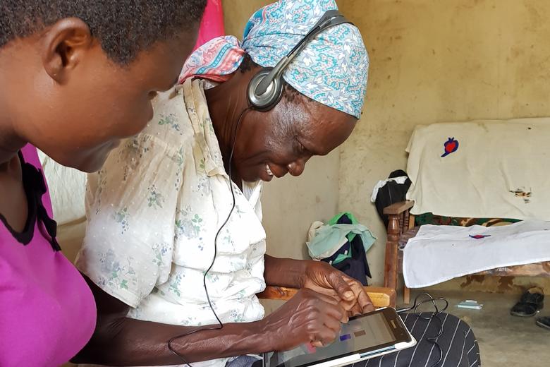 Woman completes survey on tablet in Kenya