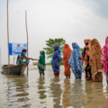 Women queueing at aid station in flood water in Bangladesh