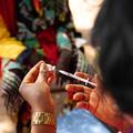 A person prepares a syringe with the COVID-19 vaccine, close up of hand and cooler box.
