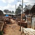 Outside of factory buidlings with piles of wood in Addis Ababa