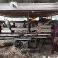 Men carrying planks of wood inside a factory in Addis Ababa