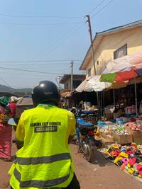 Kenema City Council representative in yellow high visibility jacket in Sierra Leone