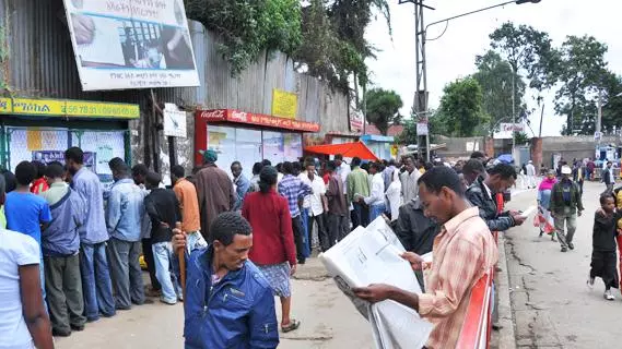 Lots of people look at job listings on the street in Addis Ababa