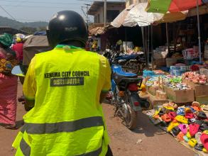 Kenema City Council representative in yellow high visibility jacket in Sierra Leone