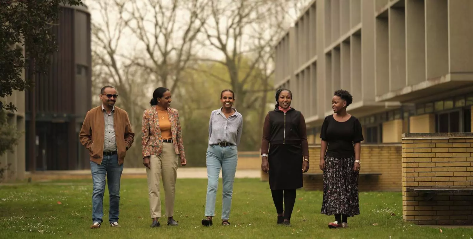 photograph of 2025 CSAE visiting fellows walking on the grass