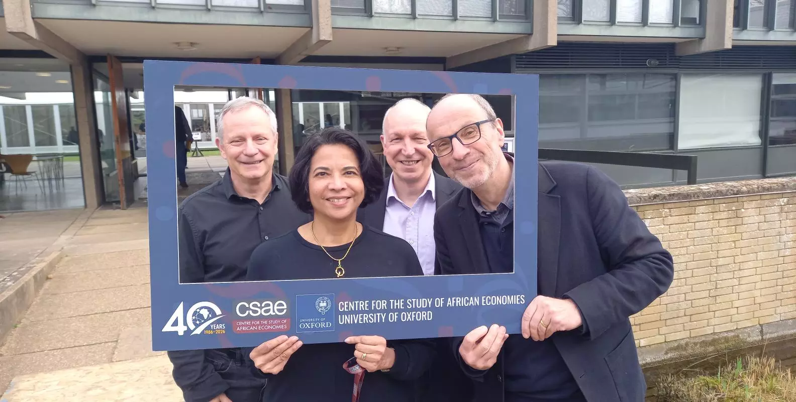 Photo of John Hoddinott, Pramila Krishnan, Chris Adam and Stefan Dercon in the 40th anniversary fram in 2026