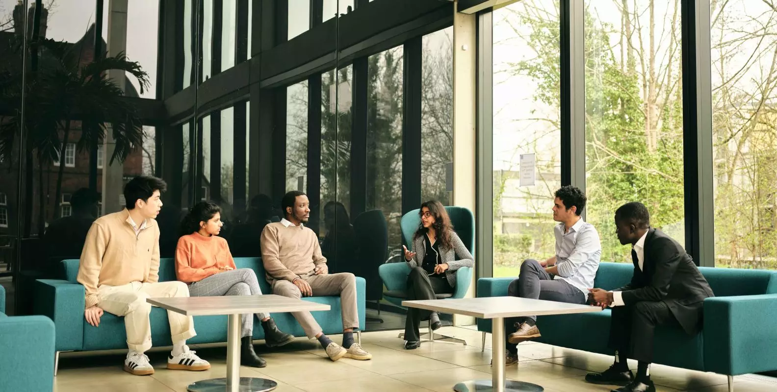 CSAE students sit and talk on sofas in the Manor Road Building in Oxford