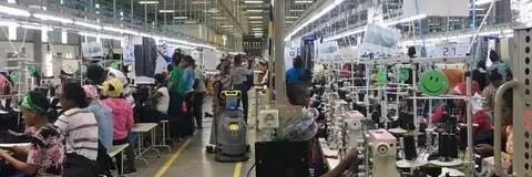 People work sewing closely together in a factory