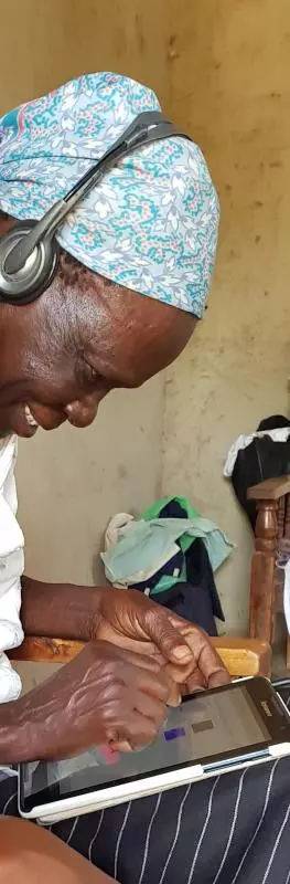 Woman completes survey on tablet in Kenya