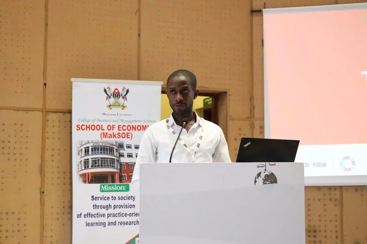 Ajapnwa Akamin presenting at a podium at the CSAE Economic Development in Africa Workshop 2023