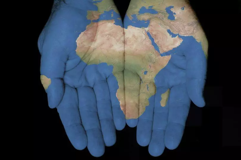 African continent projected on to open hands cupped together