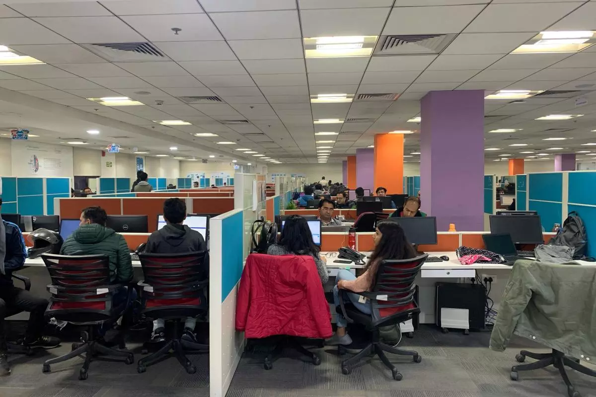 People working at computers in a shared computer space in India